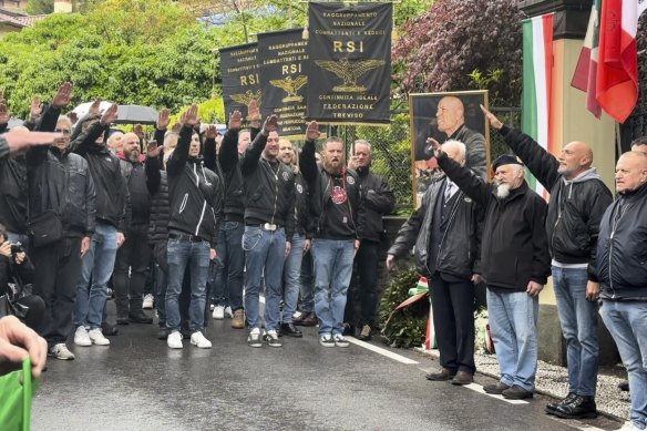 Dozens of people raise their arms to honour Italian dictator Benito Mussolini on the 79th anniversary of his execution. 