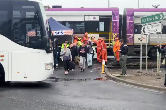 Passengers get off a V/Line train after a fatal collision with a truck at Geelong on Monday.