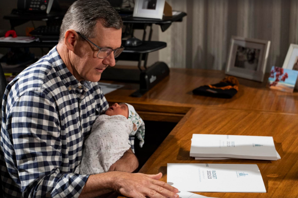 The then Northern Territory Chief Minister, Michael Gunner, with his new baby, Nash, shortly before he handed down the 2022 budget this month.