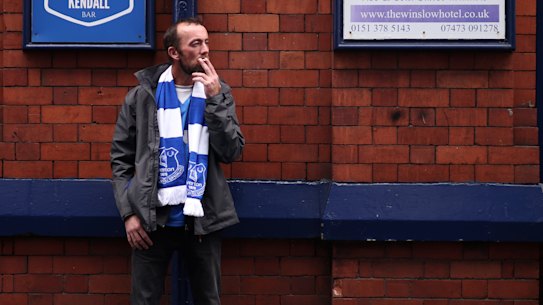 A soccer fan smokes a cigarette outside a pub in Liverpool.