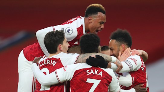 Pierre Emerick Aubameyang (right) celebrates the first of his three goals for Arsenal against Leeds.