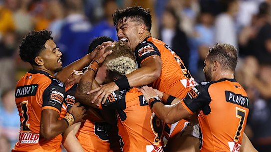 The Tigers celebrate a try.