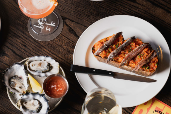 Oysters and pan con tomate finished with anchovies.