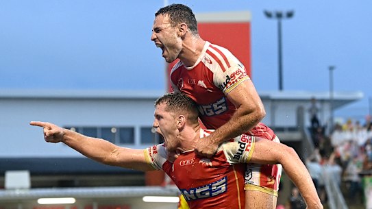 The Dolphins’ Tom Gilbert and Sean O’Sullivan celebrate scoring against the Raiders.