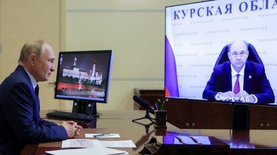 Russian President Vladimir Putin listens to acting Governor of Kursk region Alexei Smirnov during a meeting via videoconference.