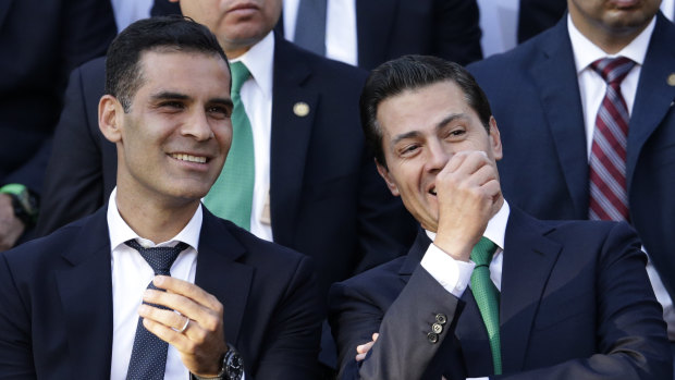 Mexican national soccer team captain Rafael Marquez, left, with Mexican President Enrique Pena Nieto during a ceremony to present the national flag to the team before the 2018 World Cup, at Los Pinos presidential residence, in Mexico City, last month. 