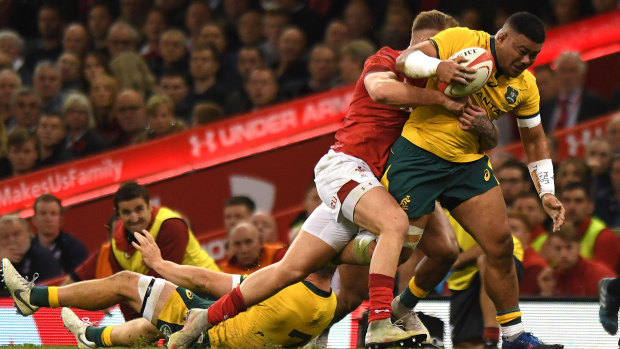 Getting the basics right: Tolu Latu makes some hard yards against Wales.