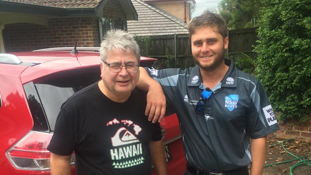 Nick Bertus and his dad, Nigel, outside the family home. 
