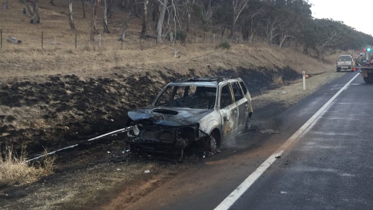 The burnt-out remains of a car that hit a kangaroo on the Monaro Highway near Michelago on Monday morning.