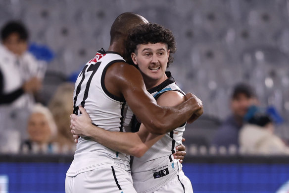 Port Adelaide’s Esava Ratugolea and Darcy Byrne-Jones celebrate a goal in Port’s thrilling win. 