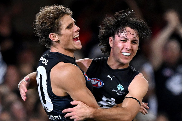 Charlie Curnow and Oliver Hollands celebrate a goal.