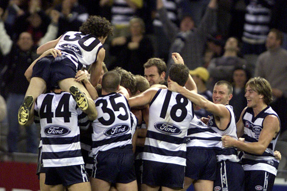 Geelong hero Peter Riccardi celebrates with teammates after his match-winning goal.