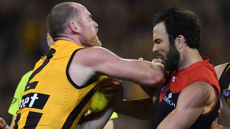 Jordan Lewis (right) gets physical with former teammate Jarryd Roughead on Friday night.