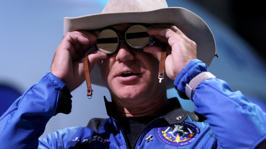 Jeff Bezos, in cowboy hat and Amelia Earhart goggles, has his eyes set on conquering space. 