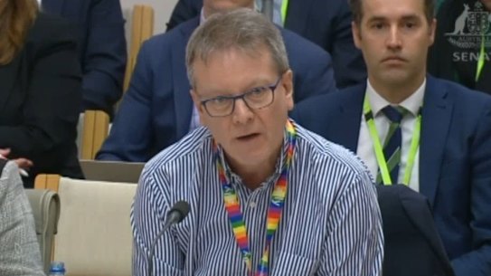 Secretary of the Infrastructure Department, Jim Betts, answers questions at Senate estimates about a T-shirt he wore.