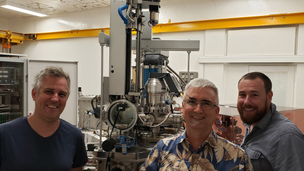 Curtin University researchers Associate Professor Nick Timms (left), Senior Research Fellow Dr Aaron Cavosie (centre), and Professor Chris Kirkland (right), pictured with the instrument used for dating the impact: A sensitive high resolution ion microprobe.
