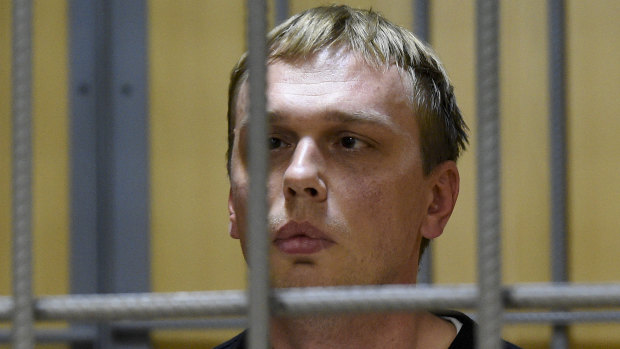 Ivan Golunov, a prominent investigative journalist, sits in a cage in court in Moscow on Saturday.
