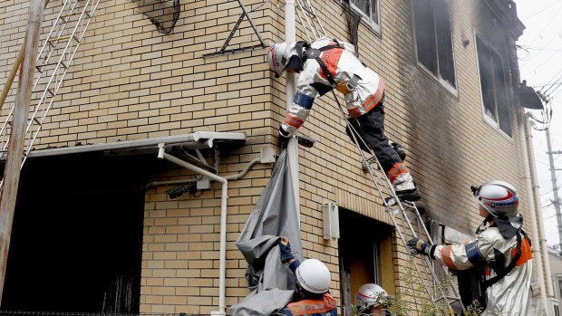 Firefighters work on the scene of the fire at the Kyoto Animation studio on Thursday.
