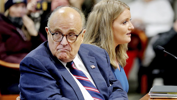 Rudy Giuliani scans the room during a Michigan House Oversight Committee hearing for suspicion of voter fraud in Lansing a few days before his diagnosis.
