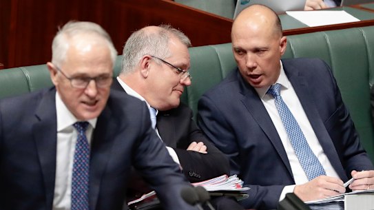 Treasurer Scott Morrison speaks with Minister for Home Affairs Peter Dutton as Prime Minister Malcolm Turnbull speaks during Question Time at Parliament House in Canberra on Monday 20 August 2018. 