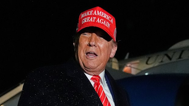 President Donald Trump speaks to reporters in the rain after arriving at Joint Base Andrews in Maryland on Friday.
