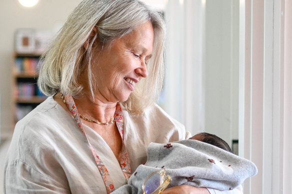 A health worker in the new family-violence crisis shelter run by Safe Steps cradles a newborn whose life, along with his mother’s was a serious risk by his father before she fled in May.