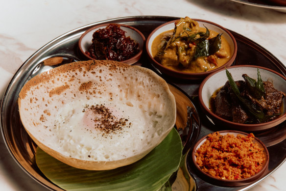 A hopper set, with an egg hopper (left), curries and sambols.