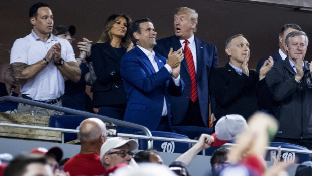 Trump, accompanied by first lady Melania Trump and Republican lawmakers, reacts as the stadium boos when he is shown on the giant screen.