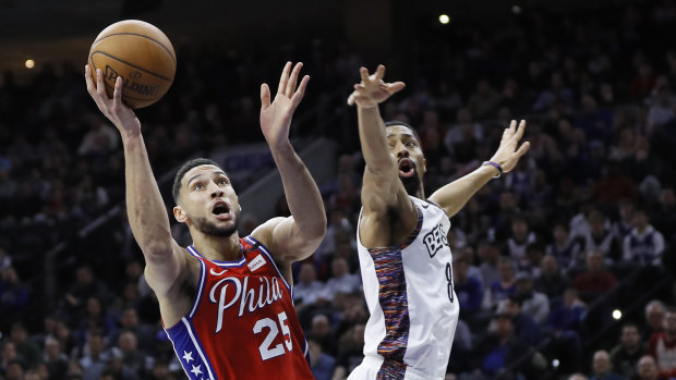 Philadelphia 76ers' Ben Simmons drives to the basket past Brooklyn Nets' Spencer Dinwiddie to score.