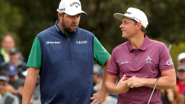 Caught short: Australian's Marc Leishman, left, and Cameron Smith talk tactics ahead of a putt on the third hole of the final day at The Metropolitan.