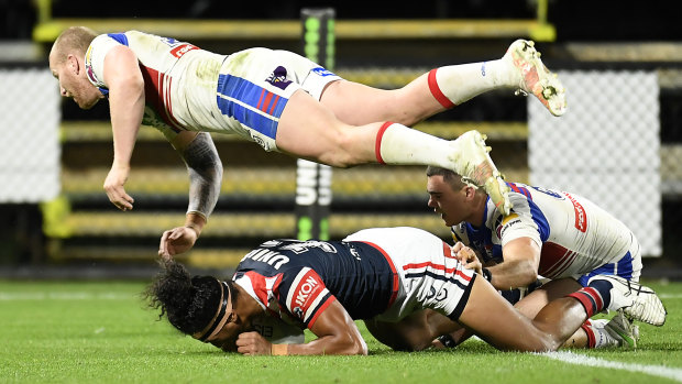 Sitili Tupouniua scores for the Roosters despite the flying effort of Mitch Barnett.