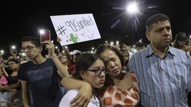 Victor Martinez along with his wife Nora Martinez and daughter Janelle Martinez, 11, grieve during the Hope Border Institute Prayer Vigil on Sunday.