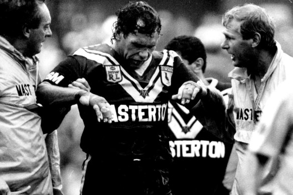 Gibbs leaves the field after suffering another head knock playing for Wests in 1992.
