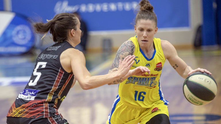 Bendigo's Nat Hurst (right) drives forward, with the WNBL title race too close to call.