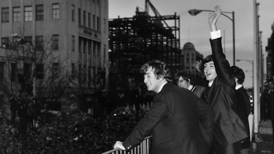 The Beatles wave to the fans from the first floor balcony of the Southern Cross Hotel, Melbourne.