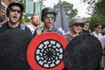 A white supremacist with the black sun on his shield at a Charlottesville rally in 2017, which turned deadly. 