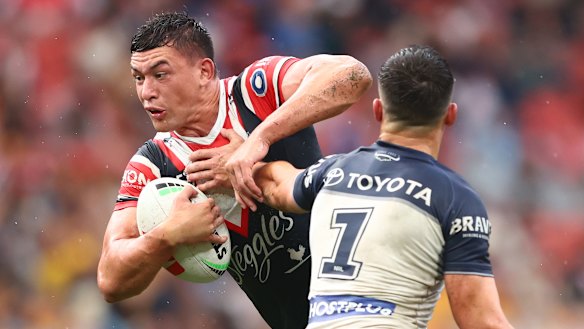 Roosters five-eighth Joseph Manu is tackled by Scott Drinkwater.