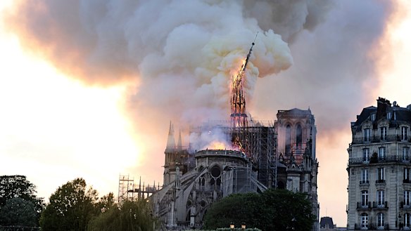Flames and smoke rise as the spire on Notre-Dame Cathedral collapses.