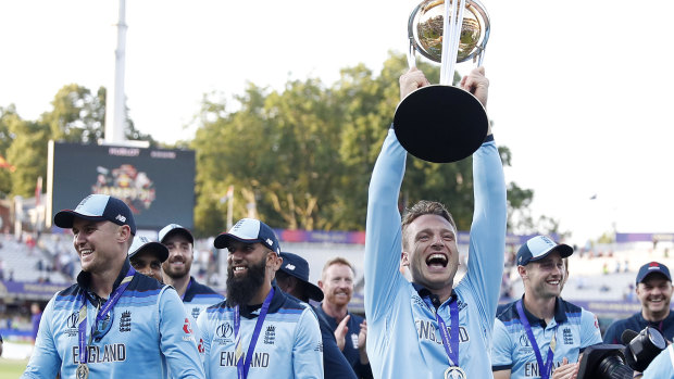 Jos Buttler lifts the trophy as England celebrate their remarkable win over New Zealand.