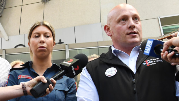 Victorian Ambulance general secretary Danny Hill and victim Monica speak to the media outside court on Monday.