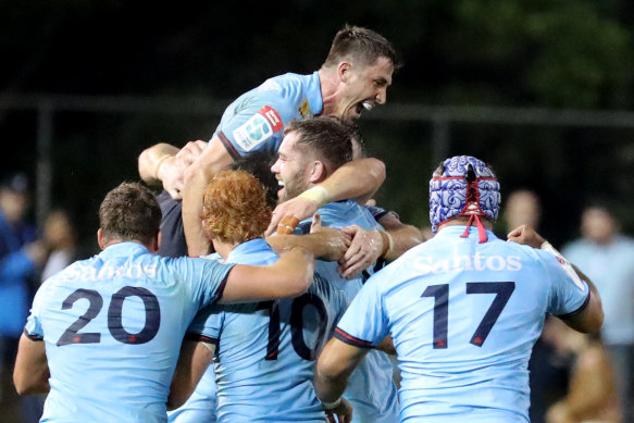 Waratahs players celebrating after beating the Crusaders.