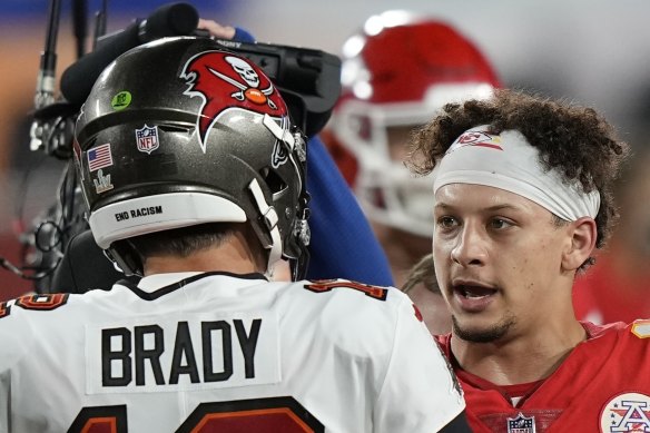 Tampa Bay Buccaneers quarterback Tom Brady speaks with Kansas City Chiefs quarterback Patrick Mahomes. 