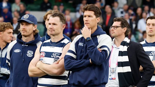 The disappointed Cats watch on at the medal presentation.