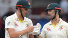 Australia batsmen Cameron Green and Mitchell Marsh fist pump as they leave the field.