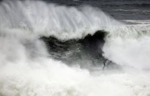 A surfer braves the swell at Tamarama.
