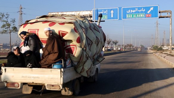A family with their goods loaded on a truck drives fleeing Idlib province. The UN says that some 60,000 Idlib residents have been displaced in recent weeks by a Russia-backed government offensive.