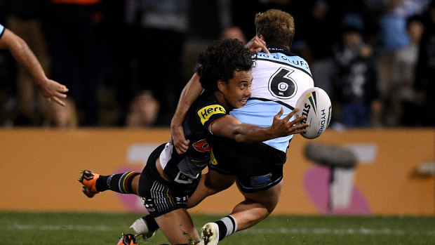 Livewire: Jarome Luai of the Panthers offloads a pass as he is tackled by Matt Moylan.