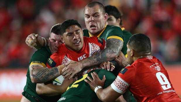 Surrounded: David Klemmer wraps up Jason Taumalolo with a bit of help.