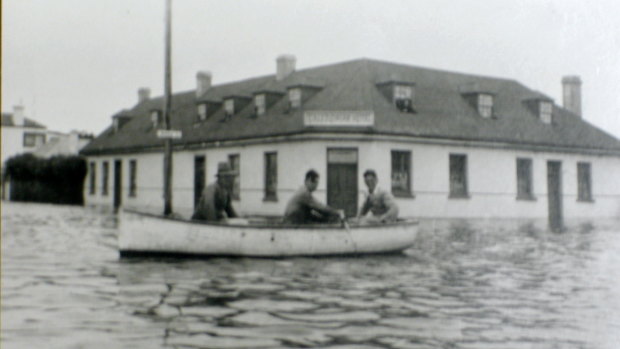 Men row a boat in Bank Street near The Stump hotel during the 1946 flood. 