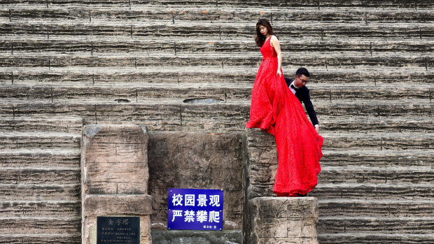 A couple climb on a replica of an Egyptian pyramid as they pose for wedding photos in Chengdu in China's south-western Sichuan province.